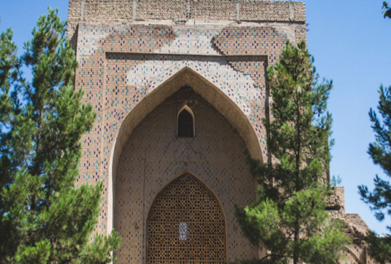 Facade and dome of the Bibi-Khanym Mosque in Samarkand under a clear blue sky